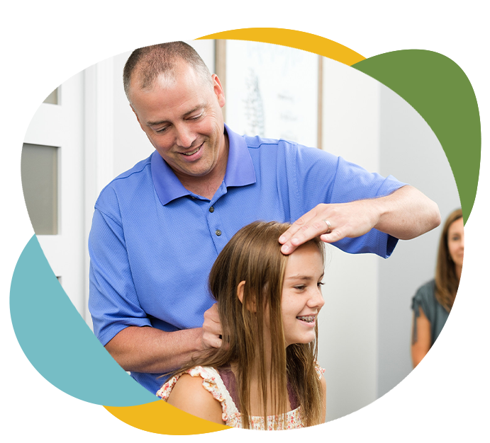 Chiropractor adjusting child neck in Woodstock, Georgia.